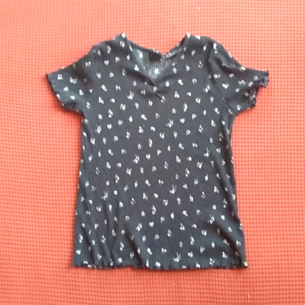 A black top with white/yellow flowers on